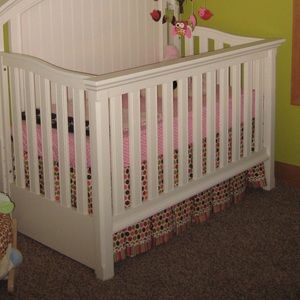 Custom made crib skirt. Shows on all sides of crib. Pink, green, brown.